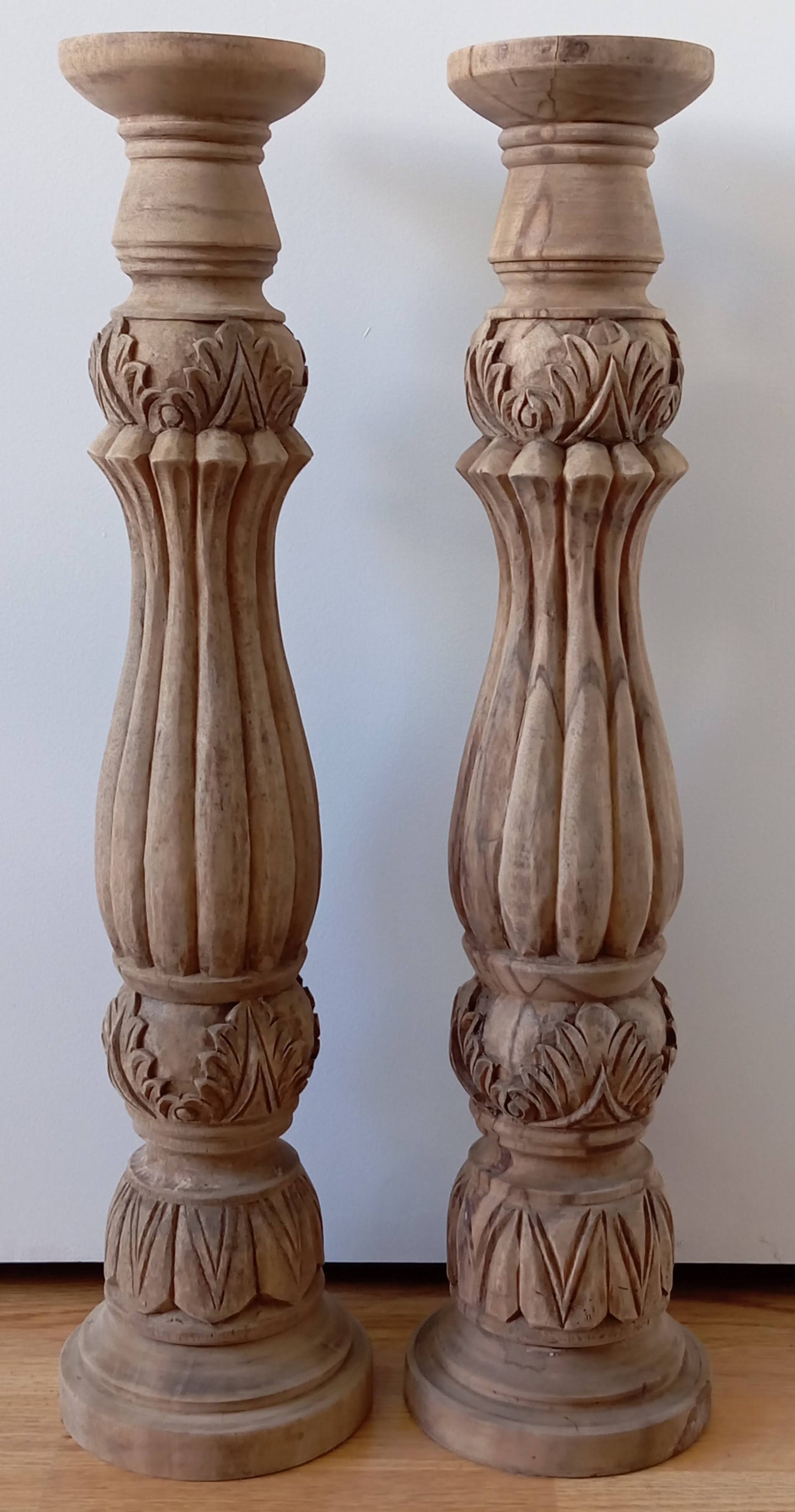Two solid wood candlesticks on a stand
