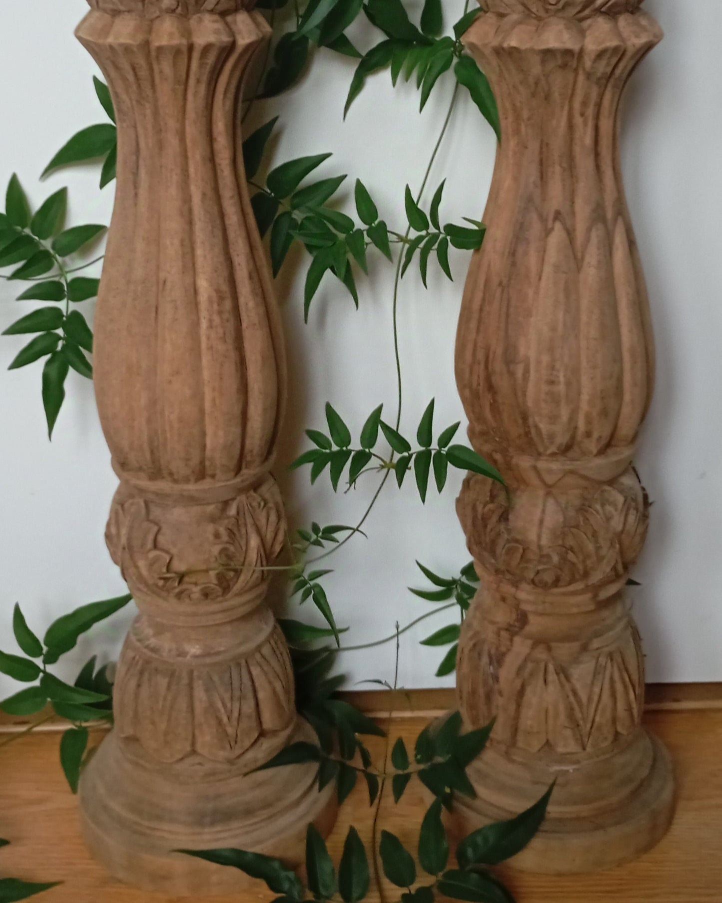 Two solid wood candlesticks on a stand