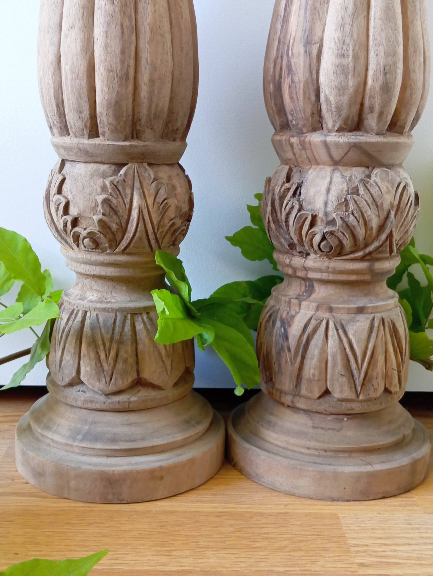 Two solid wood candlesticks on a stand
