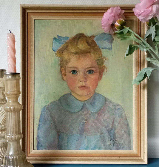 Portrait of a little girl with a blue ribbon